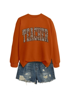 Flat lay of teacher sweatshirt with leopard print text and distressed denim shorts set