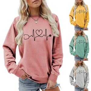 Detail of crewneck sweatshirt featuring stethoscope heart EKG print in multiple colors
