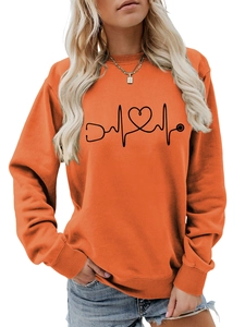 Close-up of heart stethoscope print on orange long-sleeve crewneck sweatshirt