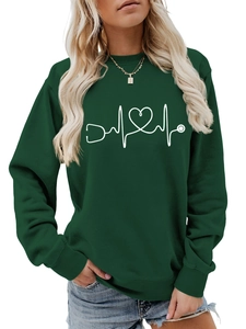 Detailed view of the stethoscope heart print on a dark green crewneck sweatshirt