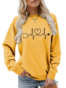 Close-up of heart stethoscope pattern on a yellow crewneck sweatshirt for women