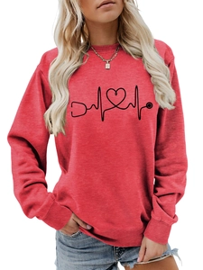 Detail of red crewneck sweatshirt featuring stethoscope and heart electrocardiogram print
