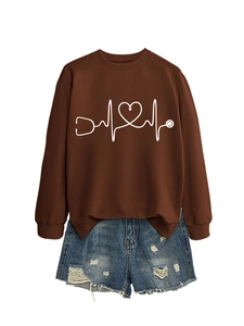 Detail of stethoscope heart print on dark brown crewneck sweatshirt with blue denim shorts