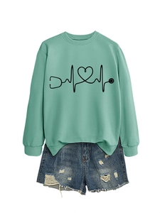 Flat lay of bean green stethoscope heart sweatshirt and frayed blue denim shorts