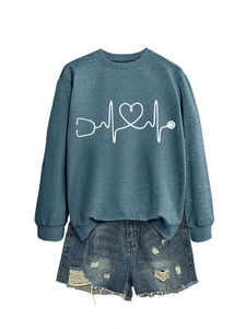 Flat lay of women's stethoscope heart sweatshirt and distressed denim shorts set