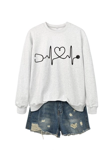 Detail of white sweatshirt with stethoscope heart print and distressed denim shorts set