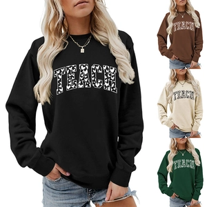 Detail view of Teach heart pattern sweatshirt showing black, brown, apricot, and green colors