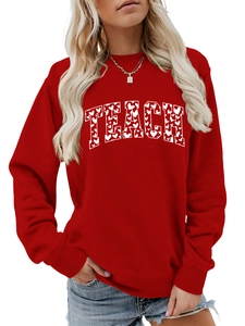 Detail of red crewneck sweatshirt with TEACH lettering and white heart pattern design