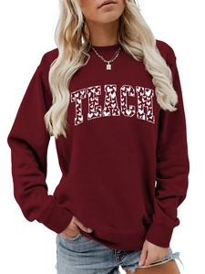 Detail of burgundy Teach sweatshirt with heart pattern print and ribbed cuffs