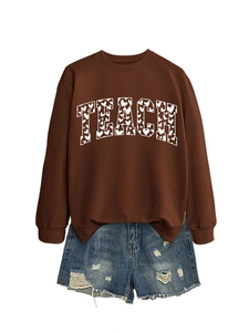 Detail of Teach letter print on brown sweatshirt with distressed denim shorts set