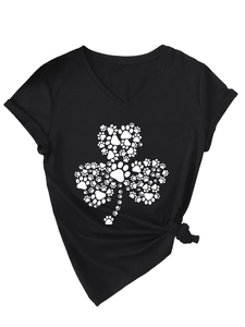 Gros plan sur le col en V et le trèfle blanc fait de pattes de chien sur un T-shirt noir