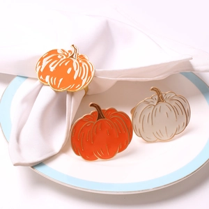 Golden Halloween pumpkin napkin rings with enamel finish in orange and white colors