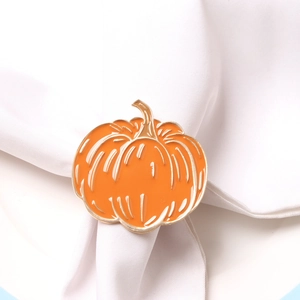 Macro shot of orange pumpkin napkin ring with gold edges for Halloween table settings