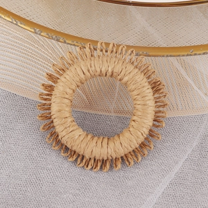 Handwoven raffia napkin ring with bohemian fringe for elegant dining table decor