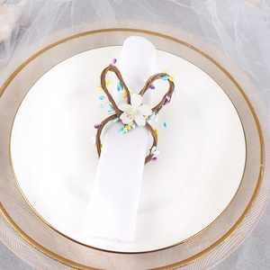 Easter rabbit ear napkin ring with woven rattan, colorful beads and a white flower detail