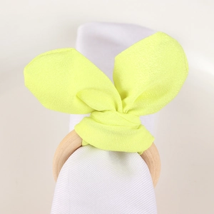 Easter bunny ear napkin ring with natural wooden circle and bright yellow fabric bow
