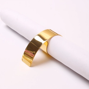 Polished gold metal open napkin ring with mirror finish for elegant table setting