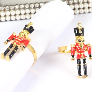 Nutcracker soldier napkin ring in gold metal with classic red and black enamel detail