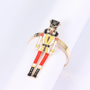 Detail of nutcracker napkin ring with enamel soldier and pearls on a white napkin