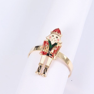 Detail of Nutcracker soldier napkin ring with gold finish and colorful enamel coating