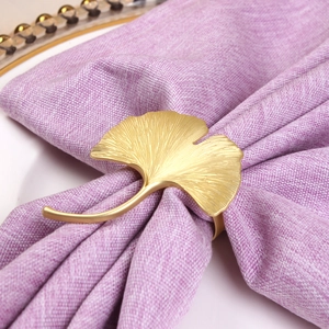 Golden ginkgo leaf metal napkin ring with lifelike veins on a lavender linen napkin