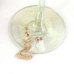 Golden cobra wine glass charm with textured snake pendant and decorative metal beads
