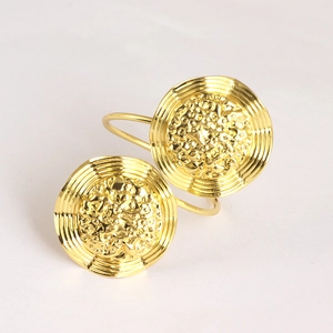 Set of two gold hammered metal napkin rings with textured floral edges for elegant tablescapes