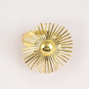 Elegant gold sunburst napkin ring with radiant metal design for wedding table setting