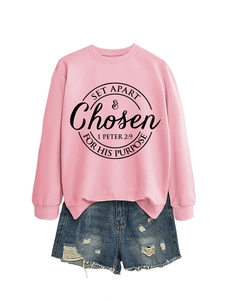 Close-up of pink crewneck sweatshirt with SET APART circular text and denim shorts