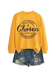 Detail of a bright yellow sweatshirt featuring Set Apart & Chosen graphic print and blue denim shorts