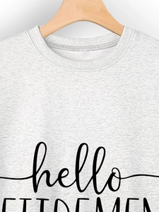 Detail of ribbed neckline and hello RETIREMENT print on gray sweatshirt fabric