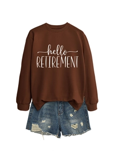 Detail of hello RETIREMENT script print on brown sweatshirt paired with denim shorts