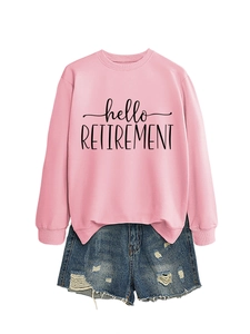 Flat lay of pink Hello Retirement sweatshirt paired with distressed denim shorts