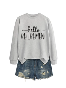 Flat lay of grey crewneck sweatshirt with hello retirement text and denim shorts
