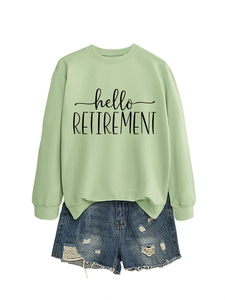 Detail of hello retirement print on light green long sleeve sweatshirt with denim shorts