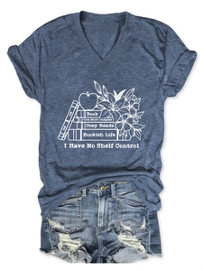 Flat lay of blue V-neck T-shirt with book graphic and distressed denim shorts