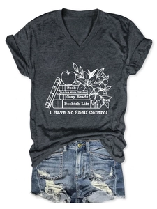 Flat lay of V-neck T-shirt with literary print and distressed denim shorts ensemble
