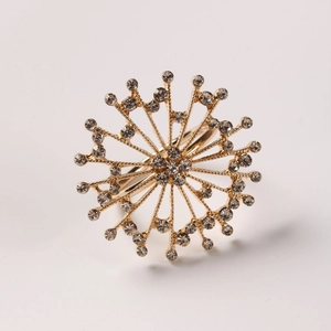 Macro detail of golden snowflake napkin ring with radiant crystals for festive table decor