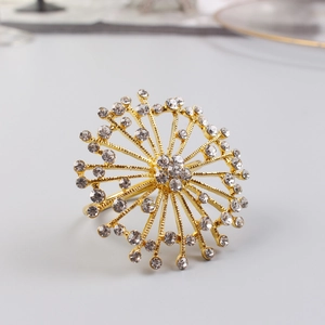 Detailed macro of golden firework napkin ring with sparkling rhinestones and metal finish