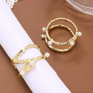 Elegant gold metal napkin ring with branch design and pearls for table decoration