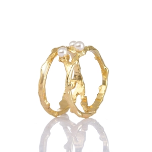 Artistic gold-plated branch texture earrings with elegant white pearls on white background