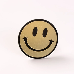 Golden smiley face napkin ring with star smile accents for elegant banquet table settings