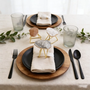 Close-up of marble napkin rings with golden tripod base in a luxury table setting