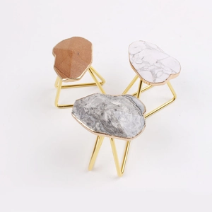 Three gold tripod marble napkin rings with agate slice details in brown white and grey colors