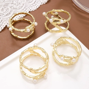 Set of 4 gold metal napkin rings with branch texture and inlaid pearls for table decor