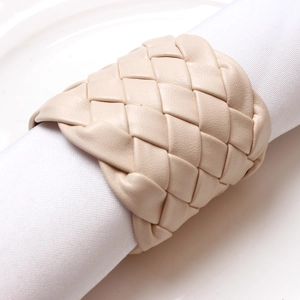 Handcrafted beige woven leather napkin ring for elegant table setting decor