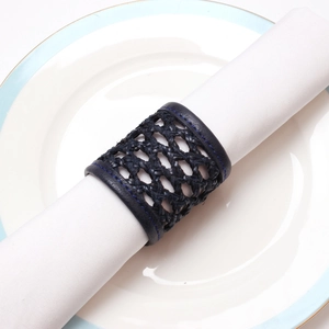 Handwoven dark blue leather napkin ring on white napkin for elegant table setting