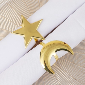 Modern gold star and moon napkin rings set on white linens for elegant table setting