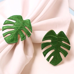 Handmade green monstera leaf embroidered napkin rings with elegant gold metal loops