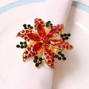 Rond de serviette fleur de Noël avec strass rouges et verts sur socle doré et assiette